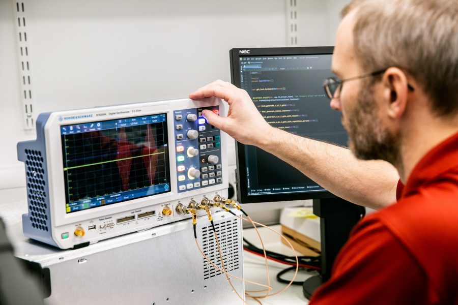 Engineering working in the OQC lab at the computer