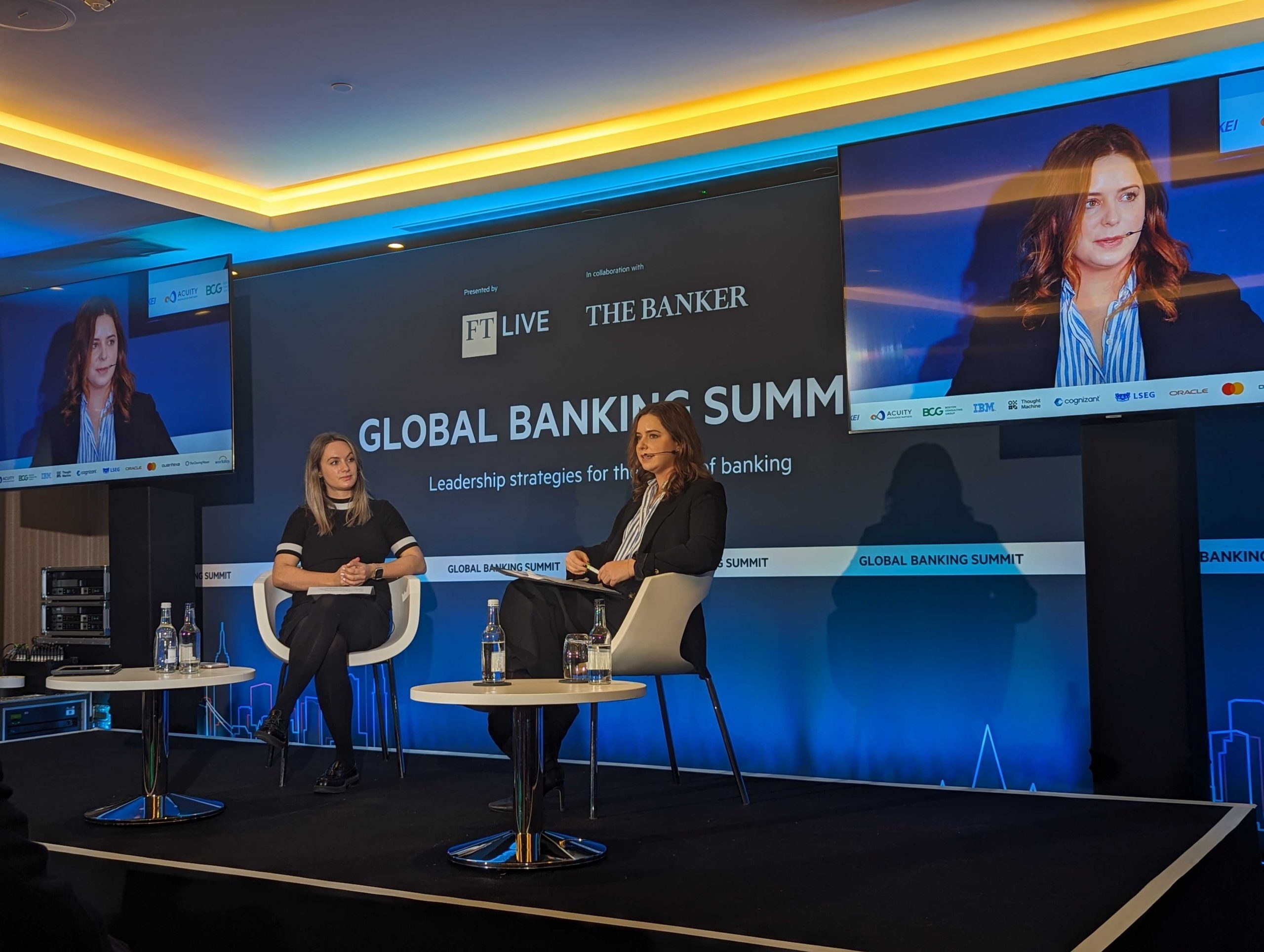 Ilana sat on stage at the Global Banking Summit with screens behind here