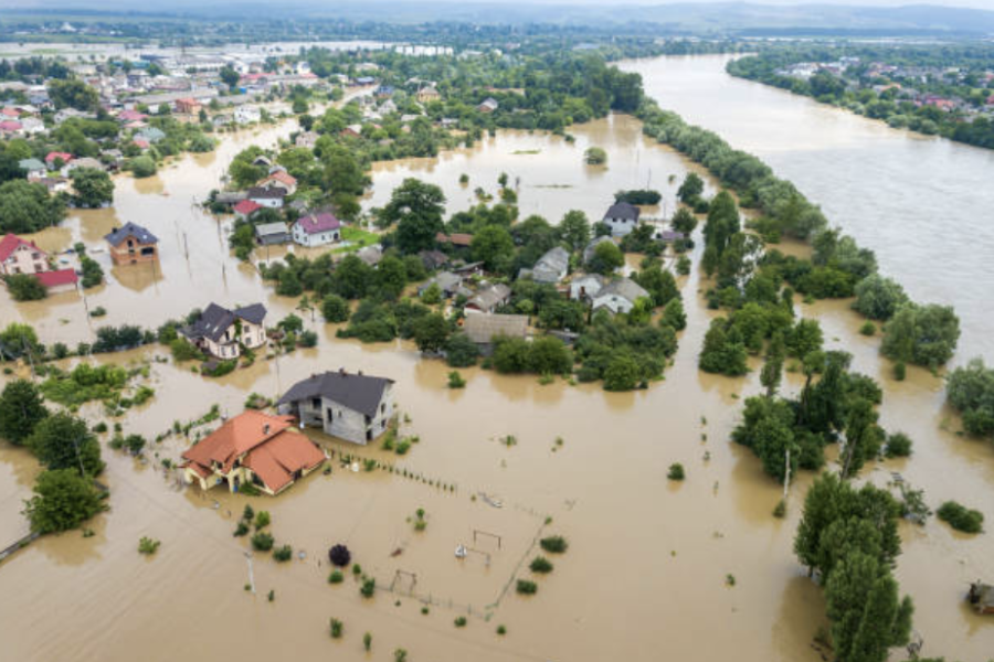 Aerial view of flooded houses with dirty water.