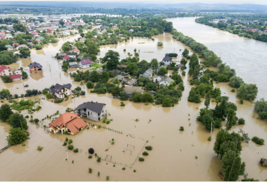 Aerial view of flooded houses with dirty water.