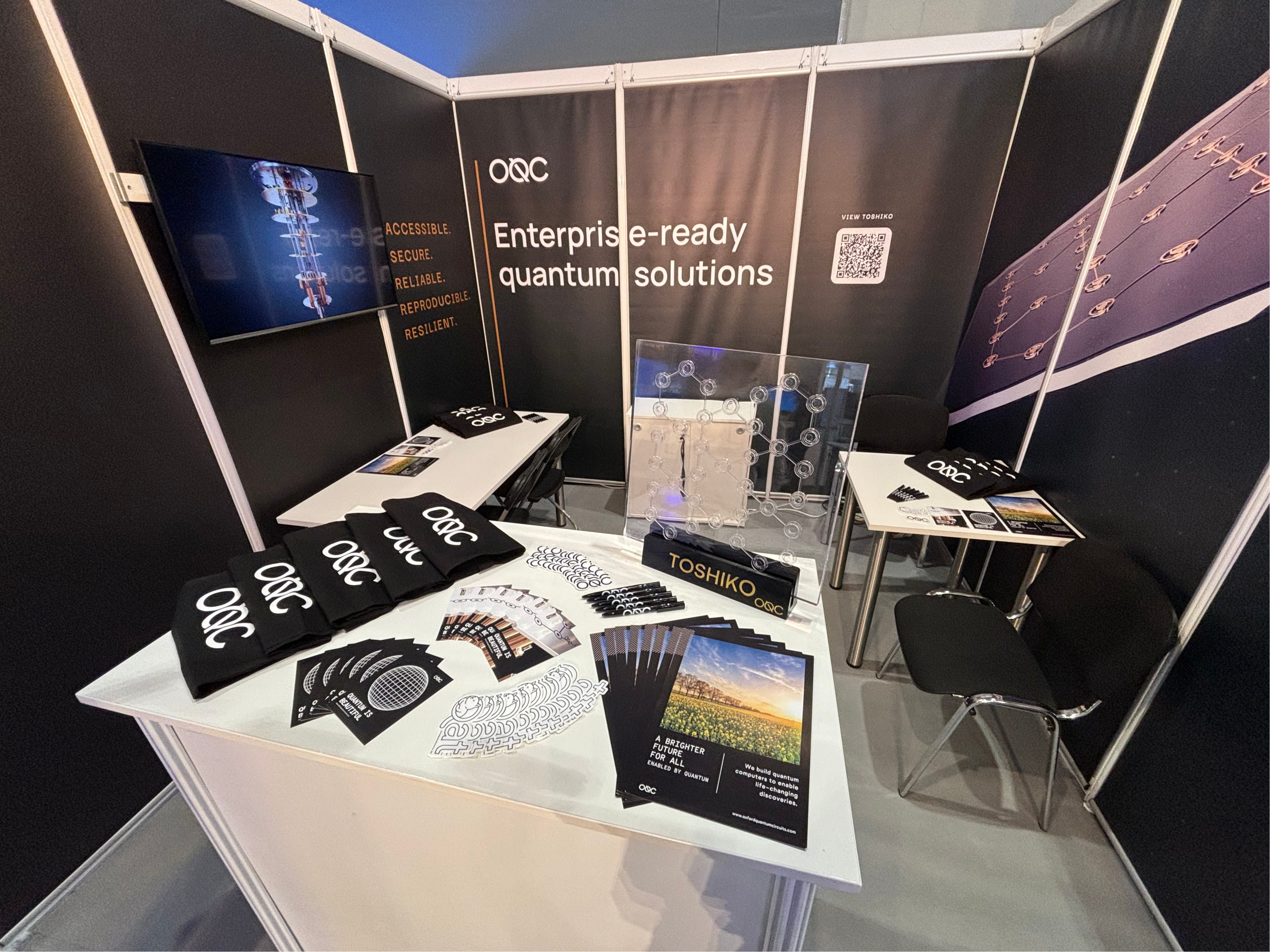 OQC's ISC 2024 stand with gift items and full print stands